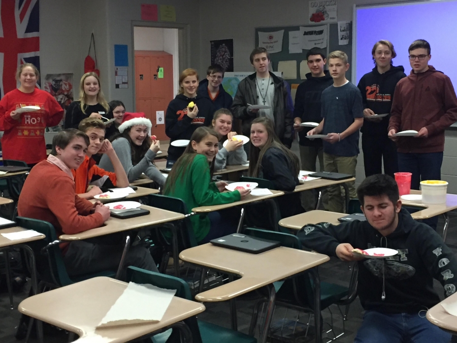 classroom of happy students eating cookies